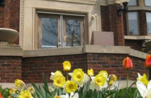 Outside view of the Tomah Library Building with Flowers in the foreground