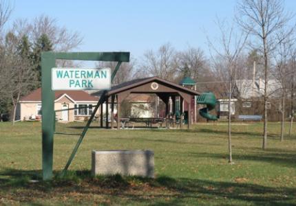 Waterman Park - a field and covered area with picnic benches. 