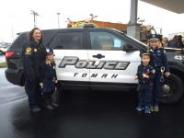 School Resource Officer standing next to a squad car with children