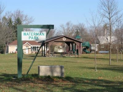 Waterman Park - a field and covered area with picnic benches. 