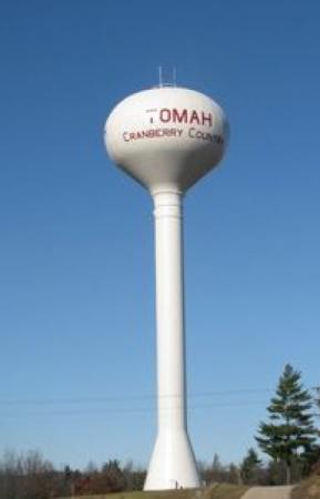 Image of a water tower with "Tomah" printed on it.